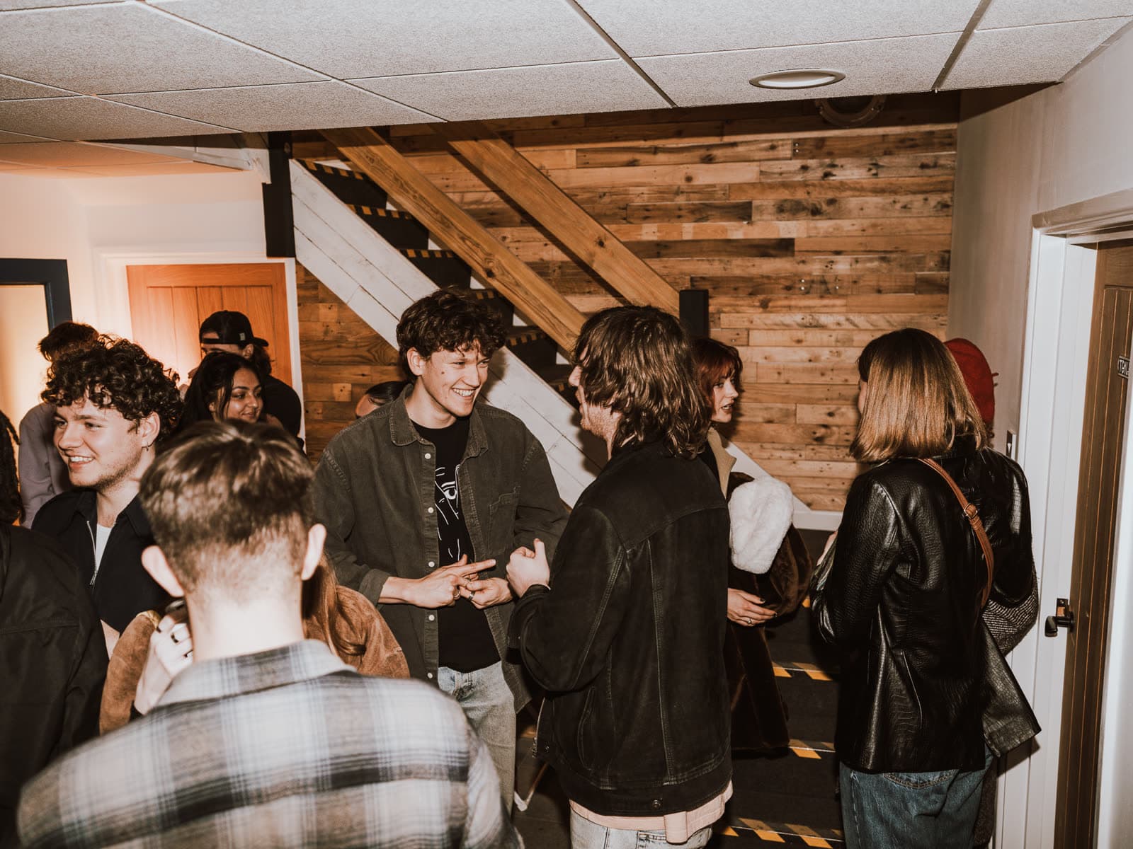 People talking in the studio's stairwell during an open session